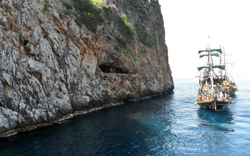 Alanya Relaxing Family Boat Tour Without Foam And Loud Music - Alanya landmarks from the water: Red Tower, Castle, and Pirate Caves