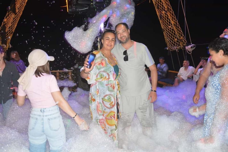 Alanya: Sunset Party Boat w/ Dinner & Unlimited Drinks - The coastline show: fortress, Red Tower, and an old shipyard